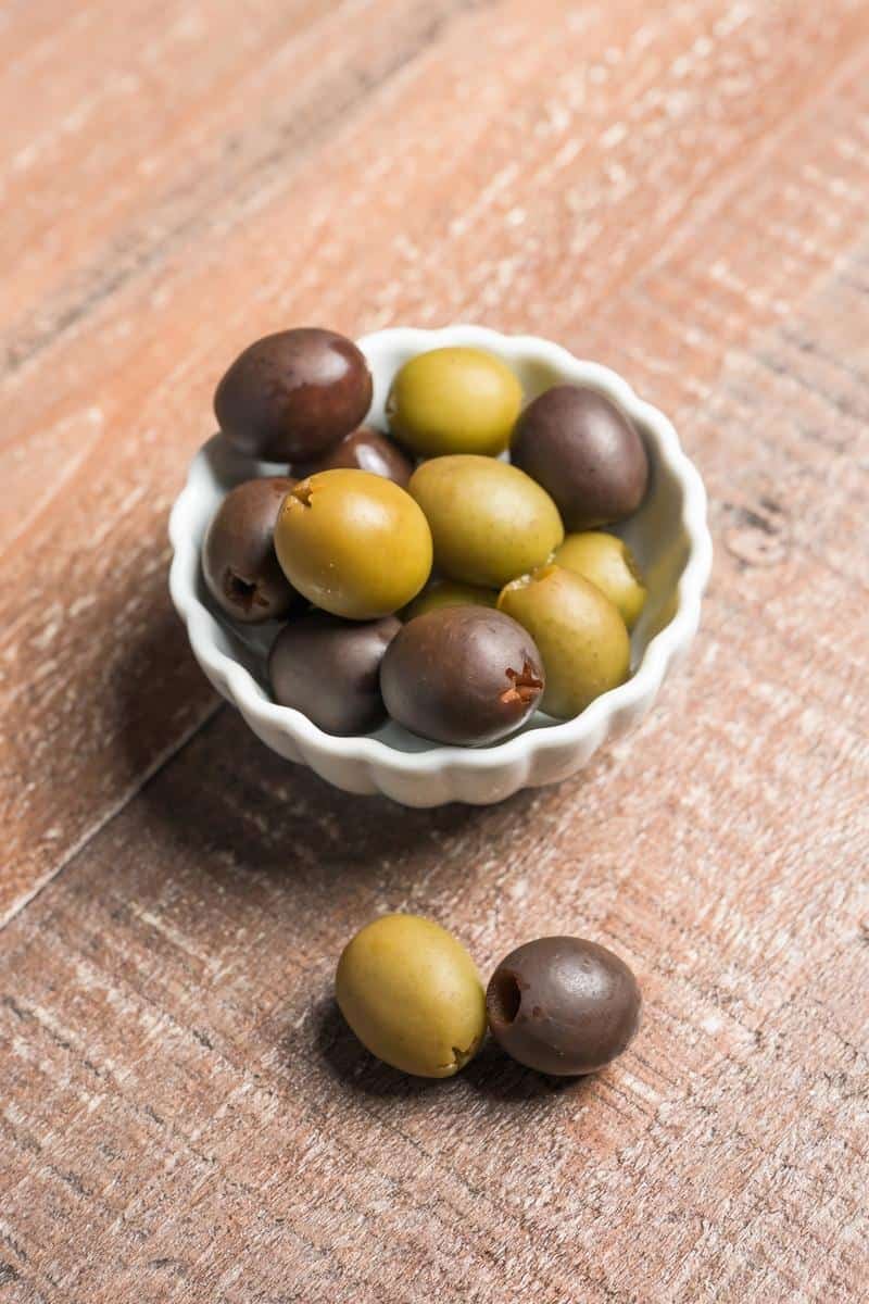 california green and black olives in a white bowl