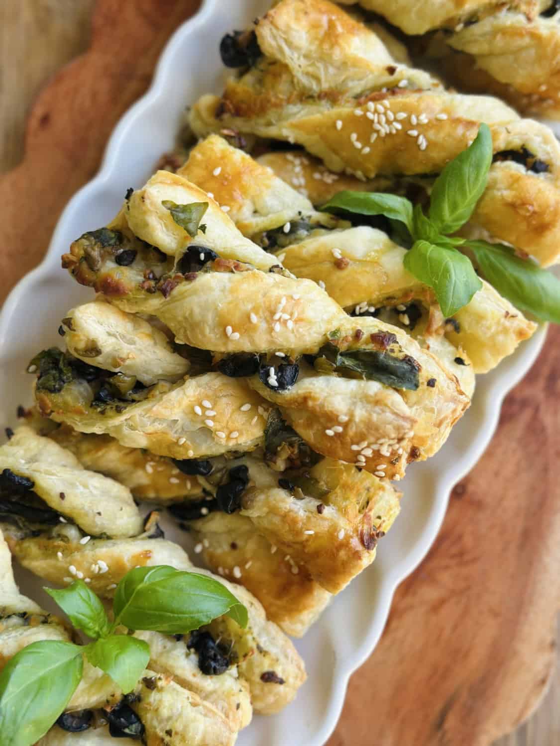 cheesy olive twists on a white platter