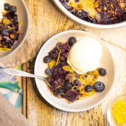 A bowl of blueberry cobbler and ice cream.