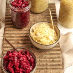 Jars and bowls of sauerkraut made with both red and green cabbage.