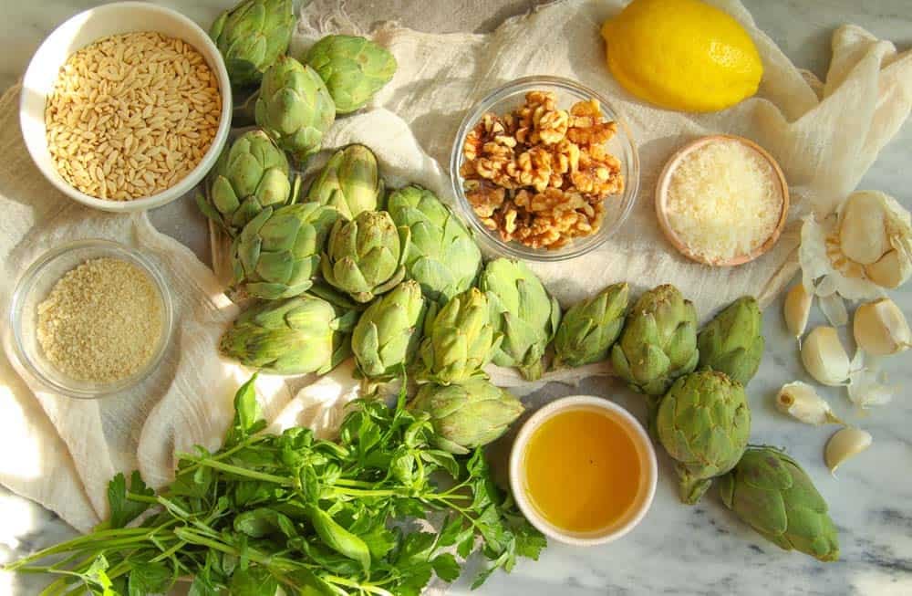 Ingredients to make this Zesty Orzo Salad with Baby Artichokes and Lemon. Fresh baby artichokes, herbs, olive oil, walnuts, bread crumbs, garlic, lemon.
