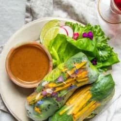 A serving plat with CA GROWN spring rolls.