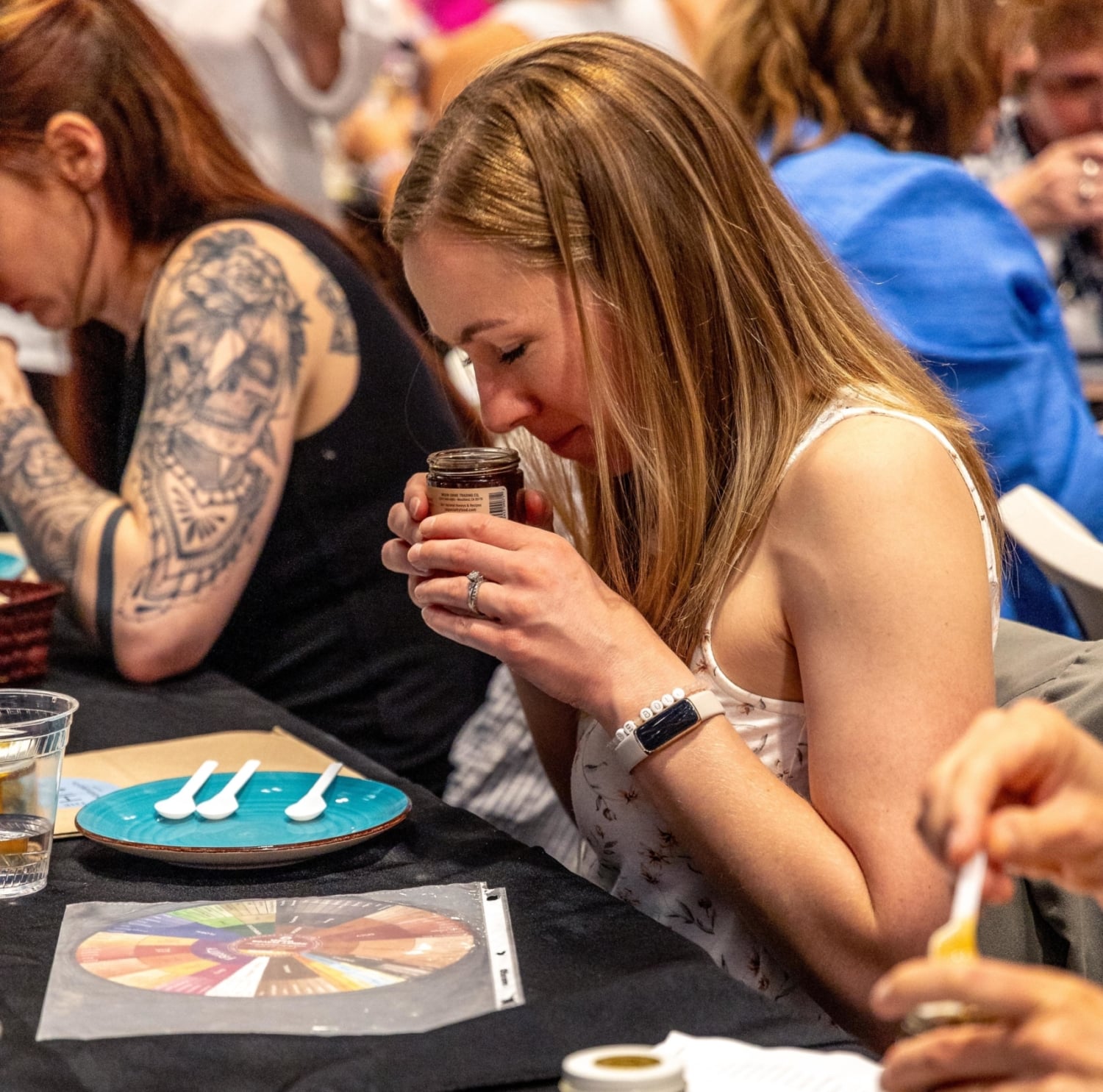 woman enjoying a honey tasting at The Hive