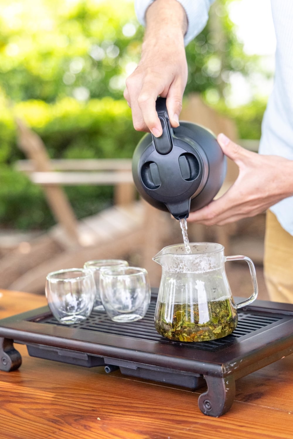 Pouring water into a tea pot full of tea leaves