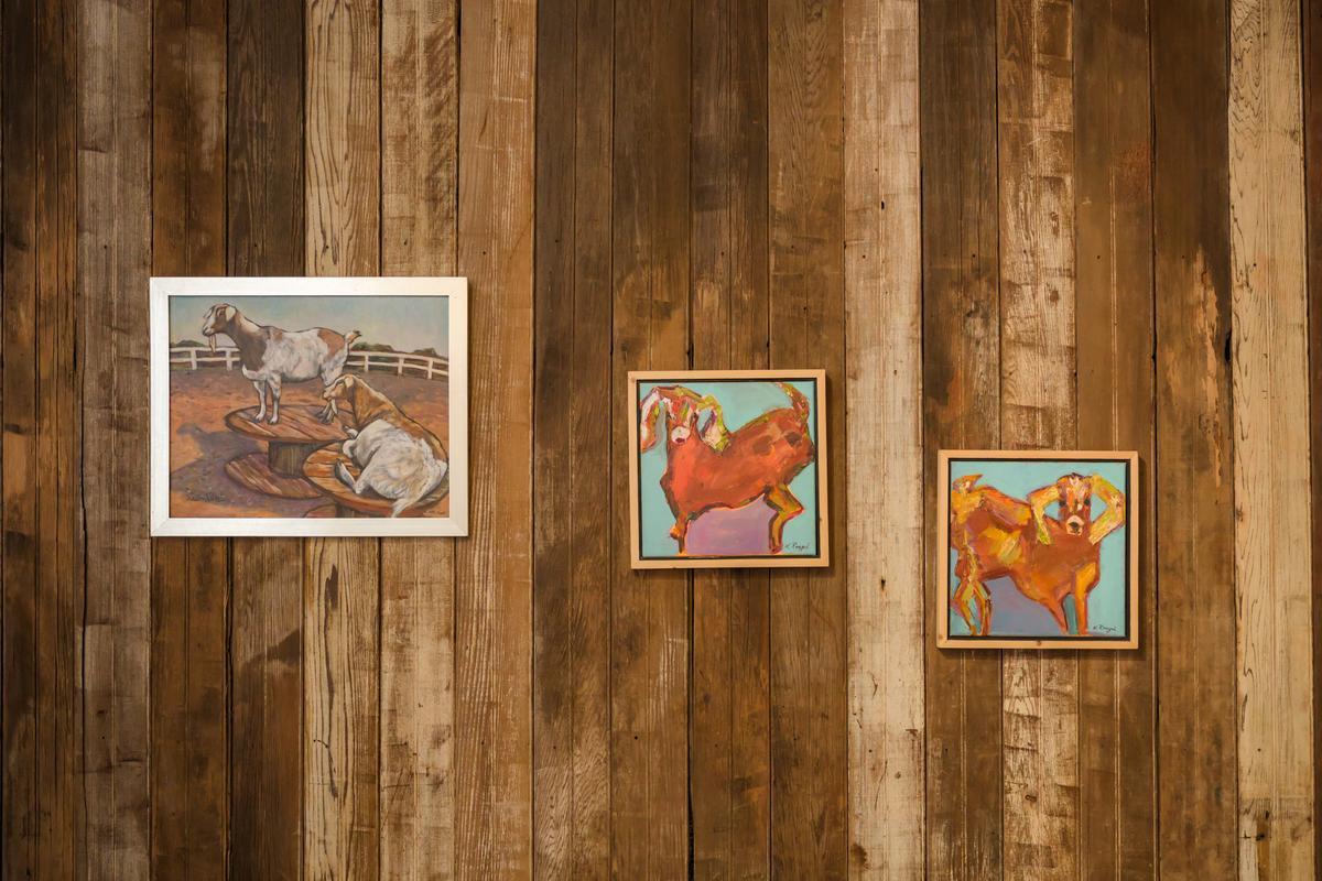 goat artwork displayed on wood plank walls