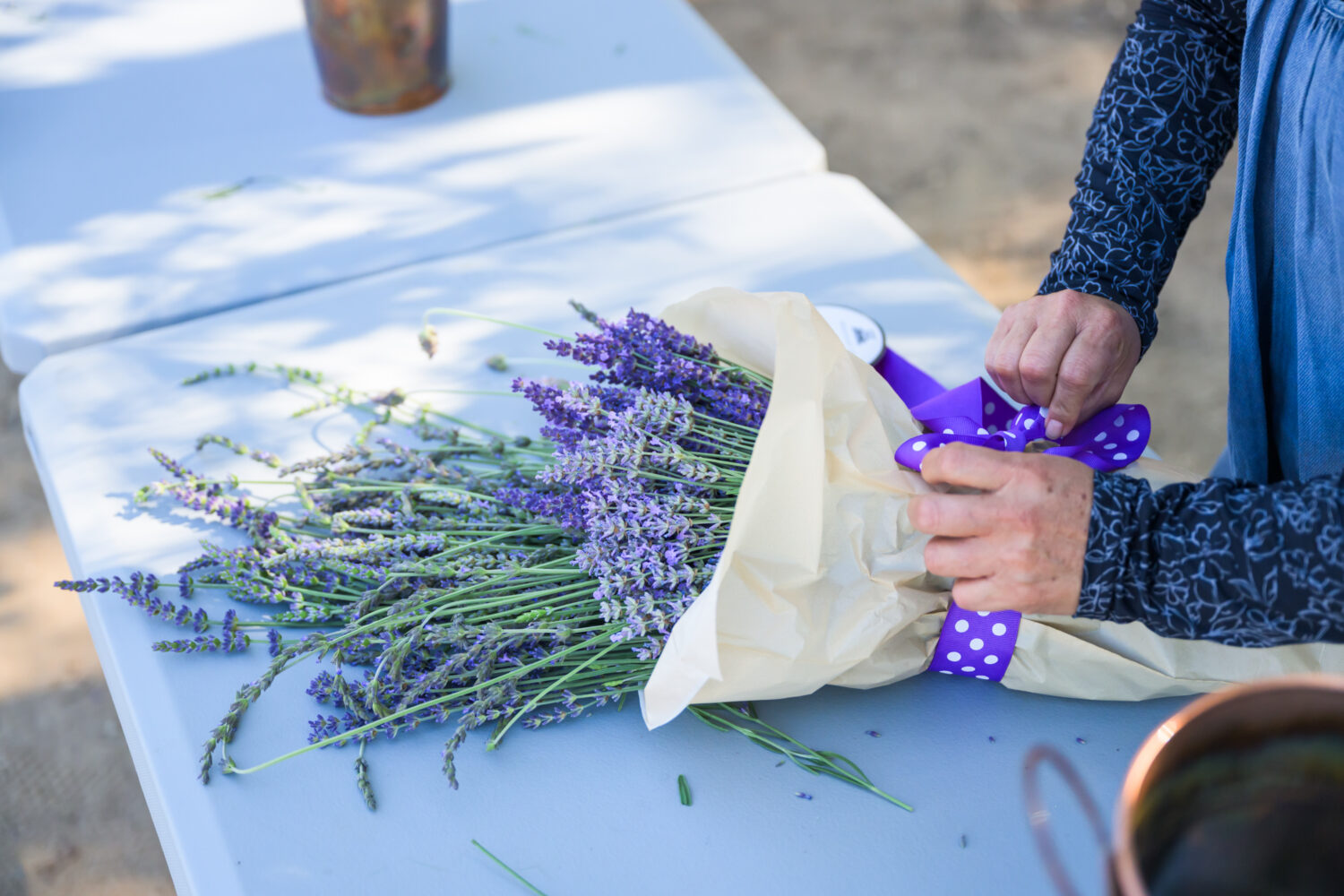 woman wrapping a lavender bouquet at Lavender Fresh Farm