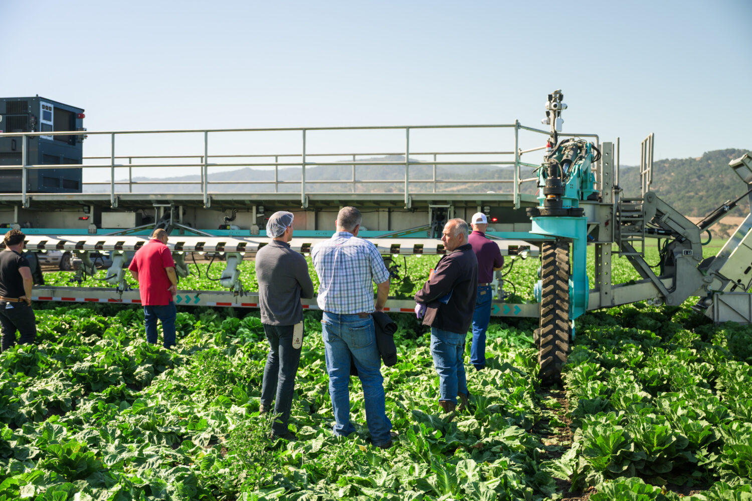 Pascal shows off the SAMI harvester to a team of farmers