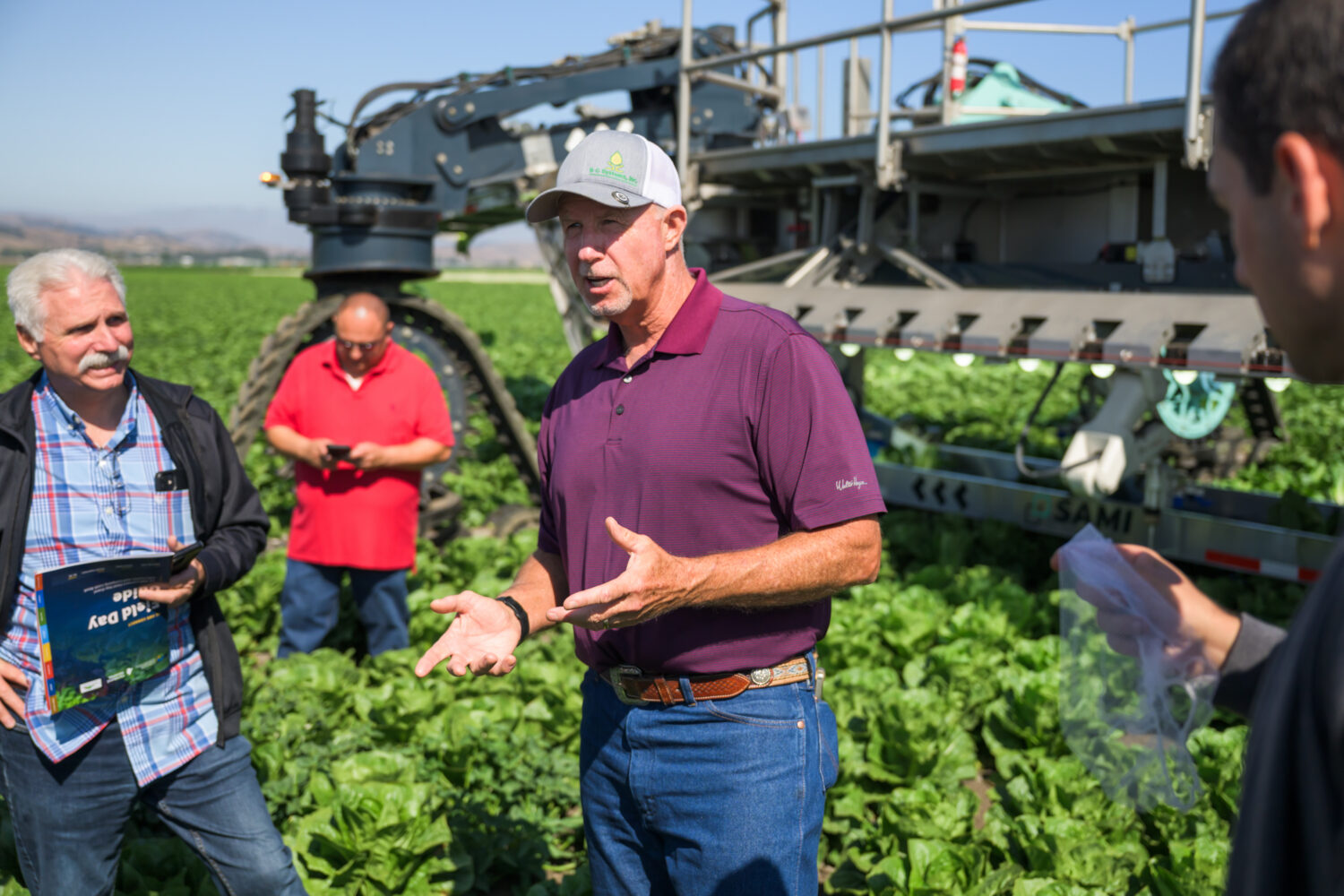 Farmers discussing the SAMI Robotic harvester